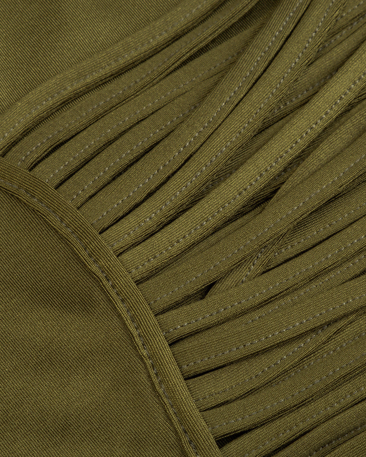 Close-up of green fabric with fringes